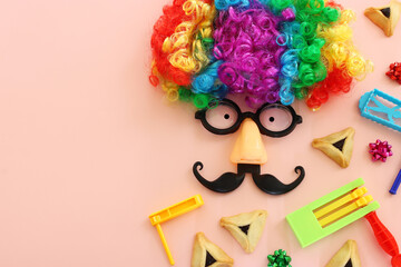 Purim celebration concept (jewish carnival holiday) over pink background