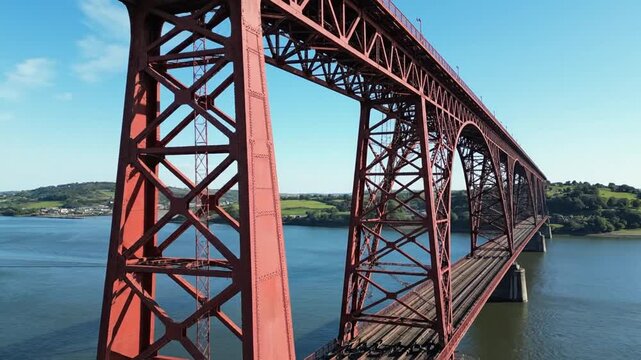 Historic red Forth Railway Bridge spanning river in Scotland