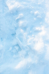 Fractional snow texture on a flat surface, winter background lighted by low sun. A snow-covered ground.