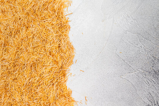 Uncooked kataifi phyllo dough threads for sweet desserts and pastry baking. Rustic flatlay with copy space