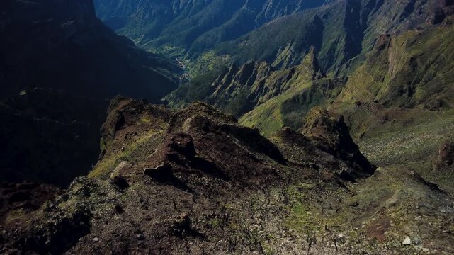 4K Cinematic Drone Descent from Pico Ruivo to Curral das Freiras: Jurassic Era Landscape, Wildfire Burned Trees to Lush Green Valley Reveal, Majestic Mountain Peaks and Volcanic Ridges of Madeira