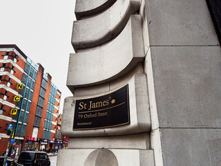 Fototapeta premium Historic St James Oxford St plaque on ornate stone arch near Manchester building in the city center