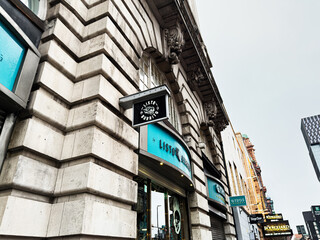 Fototapeta premium Streetside Listo Burrito storefronts in Manchester, UK showcase historic architecture and urban cityscape