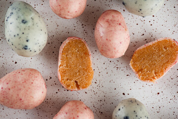 Vegan marzipan Easter eggs on a plate. Sweet candy. Sugar, gluten and lactose free. Top view.