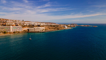 Aerial panorama of white resort buildings and turquoise waters in Spain