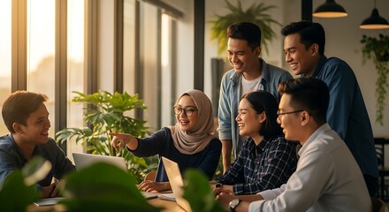 Modern Indonesian creative team brainstorming in coworking