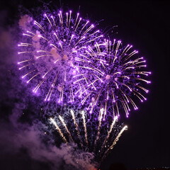 Fototapeta premium A dazzling, vibrant purple fireworks display illuminates a joyful festive event in the night sky