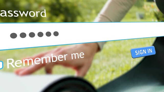 A user types their password into a website form on a computer. In the background, a woman is unrolling a sports mat on the grass for exercise or yoga.