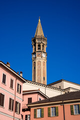 Fototapeta premium The San Nicolò Bell Tower (Campanile di Lecco) in Lecco, Italy, visible through colorful houses and buildings in the foreground. Lake Como,Italy 07.01.2026