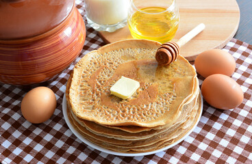 Golden Pancakes with Honey, Butter and Eggs ready for maslenitsa