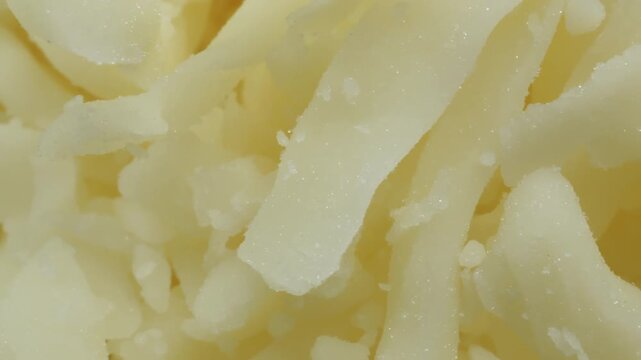 grated mozzarella cheese extreme macro close up with a rotating camera motion stock footage