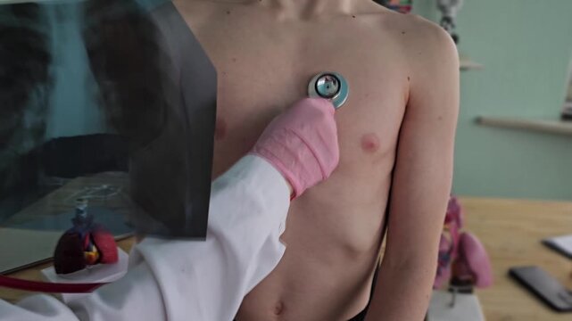 Medical checkup with a doctor listening to a child  heart using a stethoscope in a clinic environment during daytime