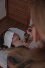 Close perspective of sound therapy using singing bowl near face