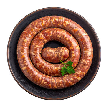 Slices of authentic kazakh kazy sausage, a horse meat delicacy, on a dark plate, isolated on a white background