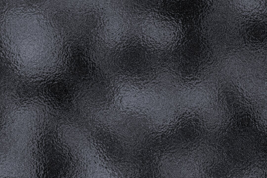 Black or dark foil glass texture background. Abstract gradient bright light reflection and shiny rough texture surface. Glass effect background