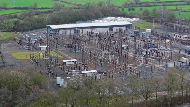 Close-up aerial view of 400kV power transformers and high-voltage switchgear at Enderby electrical substation UK, illustrating grid stability.