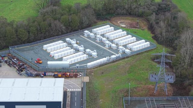 Cinematic 4K drone perspective of CATL containerised BESS technology at the Enderby power hub for national grid overload protection.