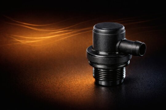 Black Automotive PCV Valve on Dark Amber Gradient Background, Precision Engine Ventilation Component, Clean Polymer Surface, Hyper Realistic Studio Lighting, Modern Car Emissions System Part