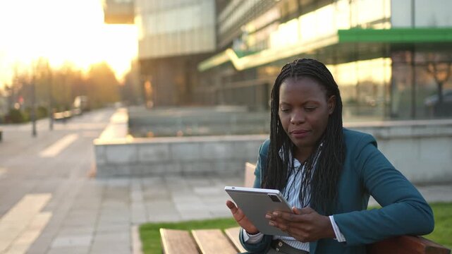 African businesswoman using a tablet during a coffee break