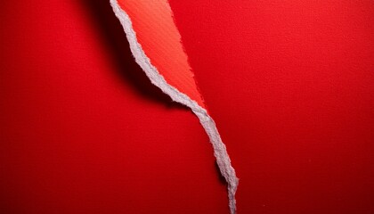 torn textured paper showing a bright red surface and revealing a raw edge
