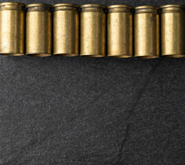Used old ammunition casings over stone background with copy space