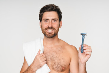 Smiling man face male model with razor in studio isolated on a white background. Epilation, cleaning and shirtless man with facial product, foam or gel to shave for wellness or hair removal