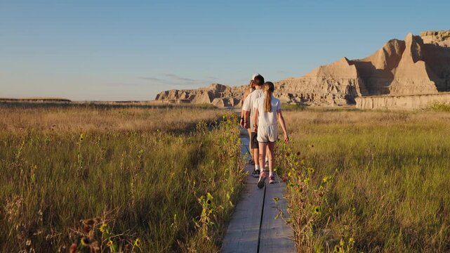 Family walk at sunset through Badlands landscape