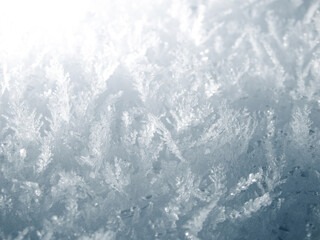 Extreme macro of intricate hoarfrost crystals and ice needles on a frozen surface.