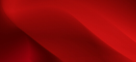 Luxurious and exclusive smooth red gradient background with soft flowing waves in a grainy texture.