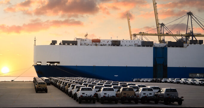 Close up vehicle carrier vessel loading car for shipping to worldwide, Large RoRo (Roll on off) vehicle car carrier, New car lined up in the port for import export around the world.