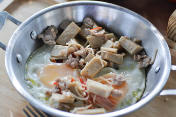 Pan fried eggs with toppings , Skillet Egg or fried egg with sausage and minced pork topping