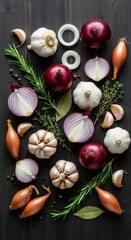 Assortment of fresh aromatic vegetables and herbs arranged on a dark wooden surface.