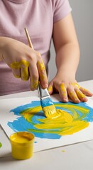 Child's Hand Painting: Swirling Hues of Blue & Yellow Expression