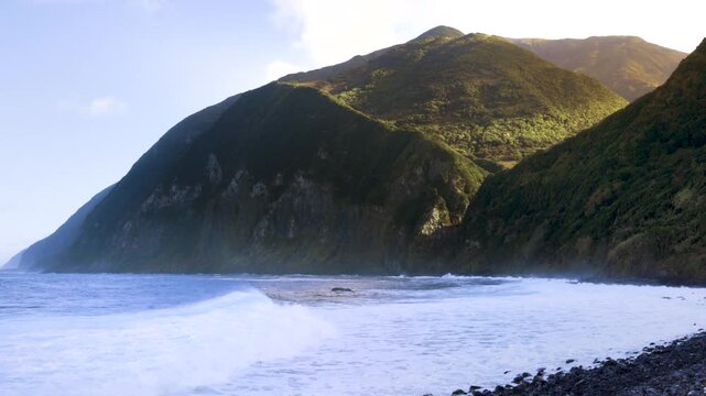 Waves in a mountain lined bay on the north coast of S&atilde;o Jorge Island, Azores