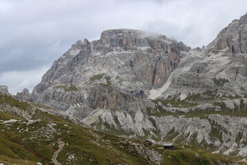 Dolomites peak rising through mist, photographed from Rifugio Locatelli on a cloudy day