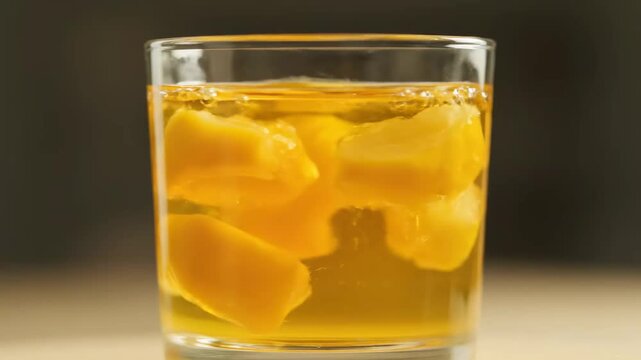 Ultra realistic close up of Tajik quince compote drink with slow rotation, cinematic traditional beverage