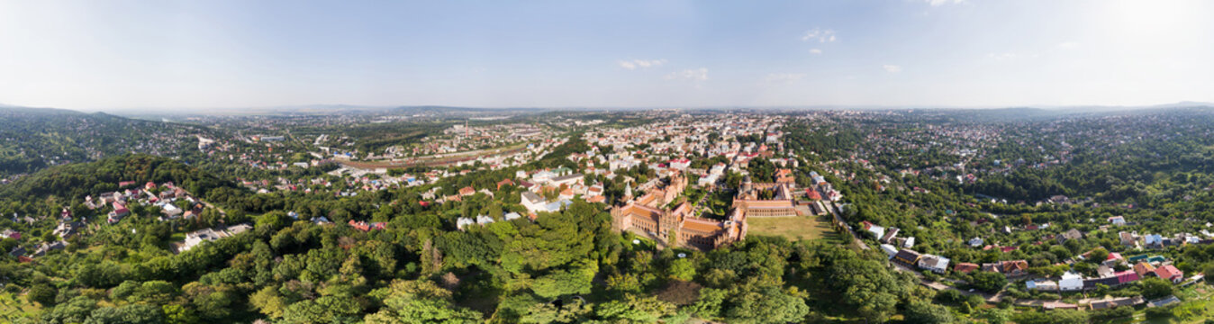 Aerial view of cityscape with terracotta rooftops, verdant parks and famous University buildings, in 360 degrees panorama created in 2017, Chernihiv, Chernihiv Oblast, Ukraine.
