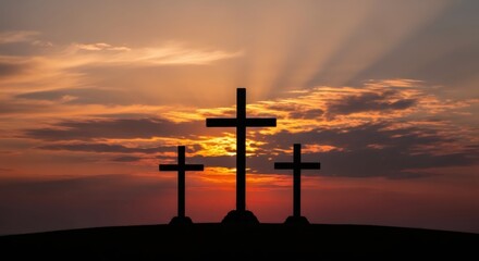Three crosses silhouetted against a dramatic sunset sky. Religious symbol of faith, resurrection concept for Easter holiday.