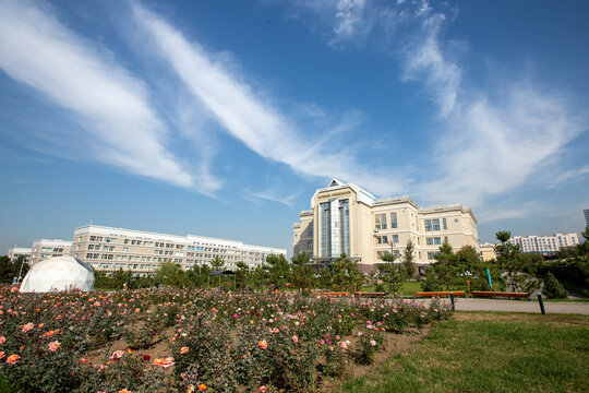 Al-Farabi Kazakh National University library building and rose garden. Almaty, Kazakhstan - September 30, 2024