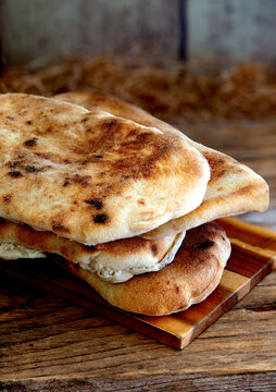 Neapolitan panuozzo bread resting on rustic wooden table
