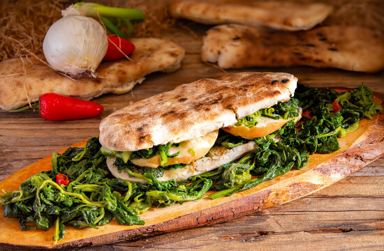 Neapolitan panuozzo sandwich with friarielli and provola cheese