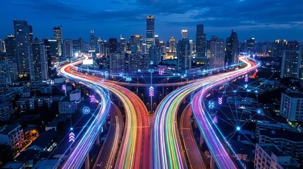 Fototapeta premium Vibrant cityscape at dusk with illuminated highway interchange and skyscrapers