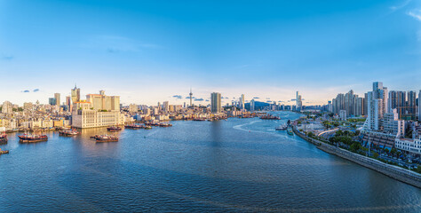 Panoramic aerial view of the Macau city skyline and harbor during a clear sunny day.