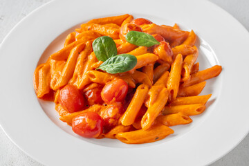 Penne pasta with roasted bell pepper emulsion cherry tomatoes Parmesan and herbs