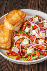 Roasted red pepper salad with feta red onion herbs and toasted crostini