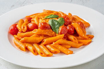 Penne pasta with roasted bell pepper emulsion cherry tomatoes Parmesan and herbs