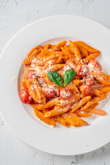 Penne pasta with roasted bell pepper emulsion cherry tomatoes Parmesan and herbs