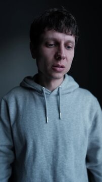 Angry man slapping his face in daylight room, self directed anger, emotional breakdown, inner conflict and psychological frustration. Vertical video