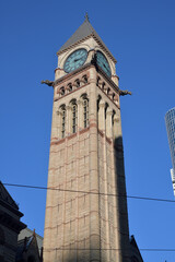 Fototapeta premium sandstone and granite Old City Hall clock and bell tower, designed by E.J. Lennox, 1899, at southwest corner, Queen and Bay, Toronto - winter