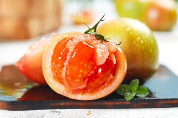 Fresh Ripe Tomatoes Cut in Half with Herbs on Slate Plate - Healthy Organic Vegetables © NguyenVan